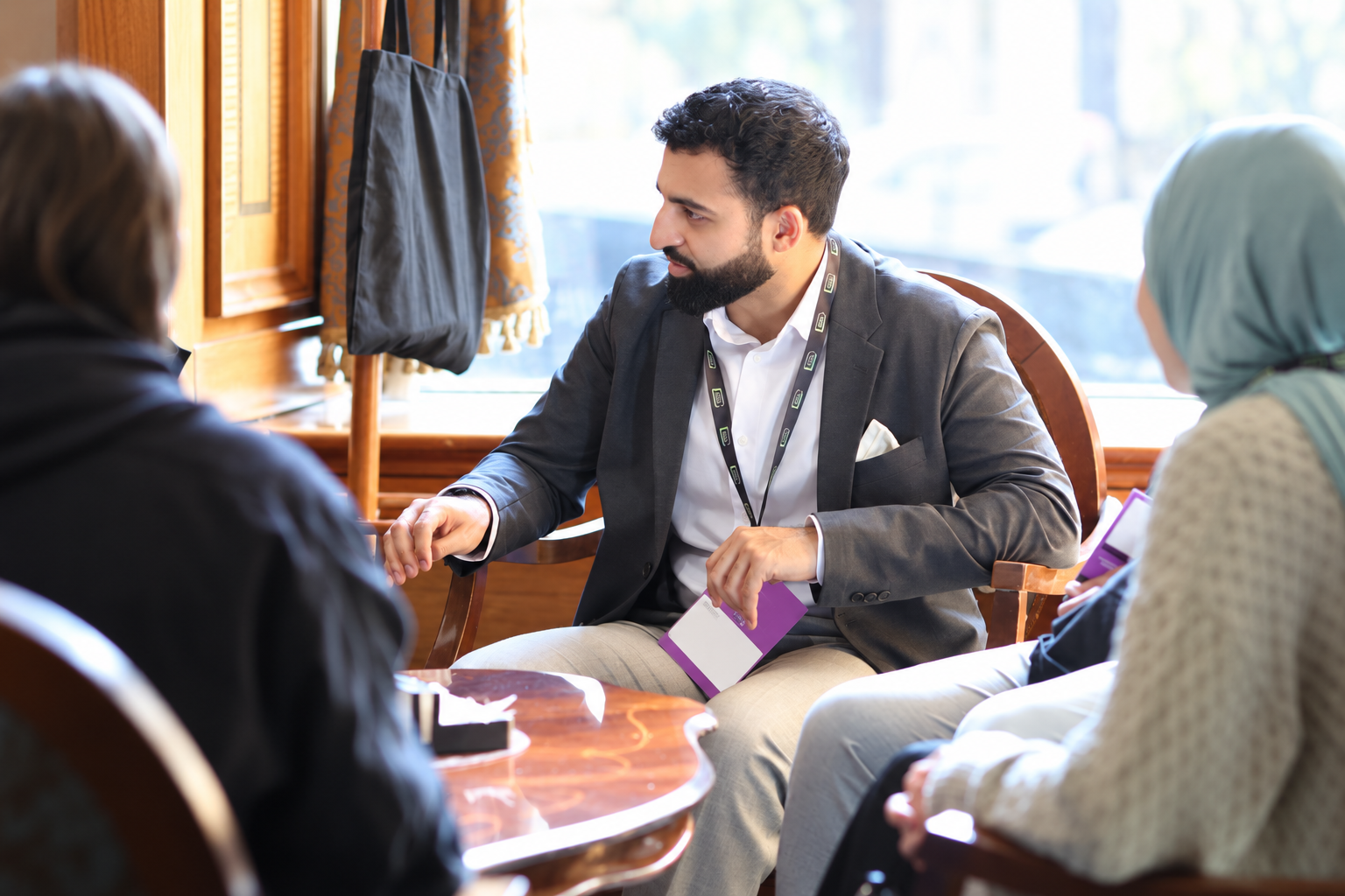 Daanish discussing ideas with two people during a mentorship conversation